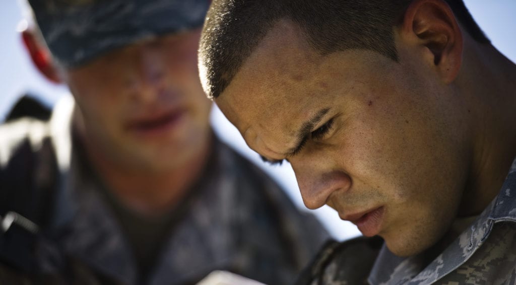 Tech. Sgt. Jarod Bomberger watches while Senior Airman Daniel West plots their course on the map Oct. 26, 2010, at Camp Bullis, Texas. Sergeant Bomberger and Airman West are going through land-navigation training and must successfully use a map, compass, and a protractor to reach several points more than 1,000 meters apart. Land navigation is one of many subjects covered in the Combat Leadership Course. (U.S Photo/Staff Sgt. Jonathan Snyder)