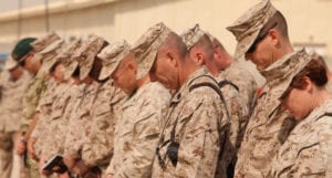 Marines and sailors bow their heads during the chaplain's invocation at Marine Wing Support Squadron 373's transfer of authority to MWSS-272 at Camp Leatherneck, Afghanistan, March 27. The transfer of authority ceremony not only symbolized the end of MWSS-373's operational responsibilities in support of Regional Command Southwest, but served as a beginning to MWSS-272's commitment in support of 2nd Marine Aircraft Wing (Forward) and its coalition partners in Afghanistan.