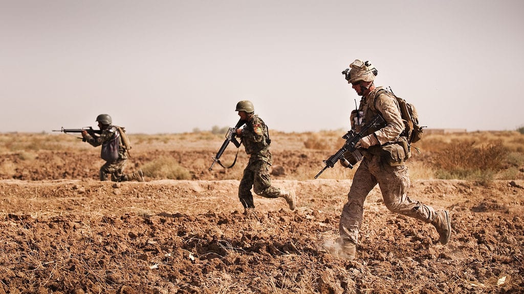 TREK NAWA, Helmand province, Islamic Republic of Afghanistan  Sgt. Charles Schneider, a squad leader with India Company, 3rd Battalion, 3rd Marine Regiment, and Afghan National Army soldiers from the 1st Kandak, 1st Brigade, 215th Corps, bound toward a road in Trek Nawa, Afghanistan, to move into a support position for squads in a firefight during Operation Black Tip, Oct. 14, 2010. Black Tip was a one-day clearing operation to disrupt enemy activity, during which the Marines and Afghan soldiers detained four men suspected of combatant activity and removed a weapons cache from the area. Schneider is from Flagstaff, Ariz. (Official Marine Corps photo by Sgt. Mark Fayloga)