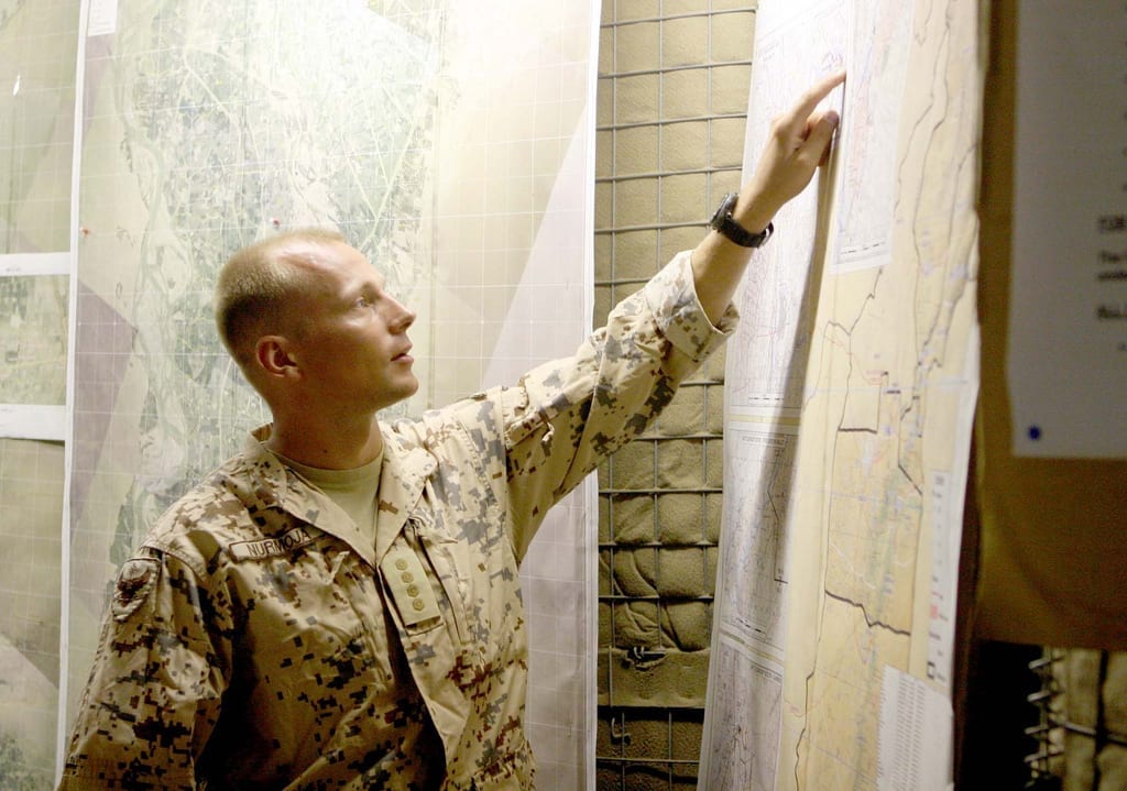 Estonian Capt. Villiko Nurmoja, liasion officer with the Estonian Army, points at a map of the province Sept. 22, 2009, during a brief of the area to discuss future operations in the area. Photo by U. S. Marine Corps