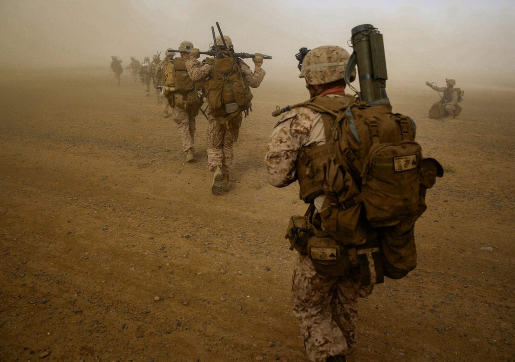 Marines with Weapons Company, 1st Battalion, 7th Marine Regiment, run to security positions after offloading from a CH-53E Super Sea Stallion helicopter during a mission in Helmand province, Afghanistan, April 28, 2014. The company's mission was to disrupt Taliban forces in Larr Village and establish a presence in the area. Five days prior to the helicopter-borne mission, the company confiscated two rocket-propelled grenades in the vicinity of the village. (U.S. Marine Corps photo by Cpl. Joseph Scanlan/Released)