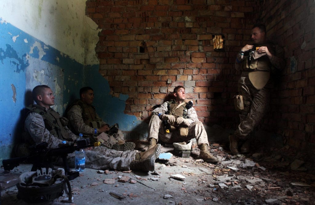 U.S. Marines pause to rest between their dismounted patrolling at Saber Strike 2012. The mortarmen and other Marines assigned to 3rd Battalion, 25th Marine Regiment, were involved in a 24-hour field training exercise to culminate the two-week event. 3/25 is a Pennsylvania-based Reserve unit. Saber Strike 2012 is a multinational, tactical field training and command post exercise that involves more than 2,000 personnel from the U.S. Army's 2nd Cavalry Regiment, Pennsylvania National Guard, 21st Theater Sustainment Command, the 4th U.S. Marine Division, the 127th Wing of the Michigan Air National Guard, Estonian, Latvian, and Lithuanian armed forces, with contingents from Canada, Finland, France and the U.K. The exercise, led by U.S. Army Europe, is designed to enhance joint and combined interoperability between the U.S. Forces and partner nations, and will help prepare participants to operate successfully in a joint, multinational, interagency, integrated environment. (U.S. Marine Corps photo by Sgt. Ray Lewis)