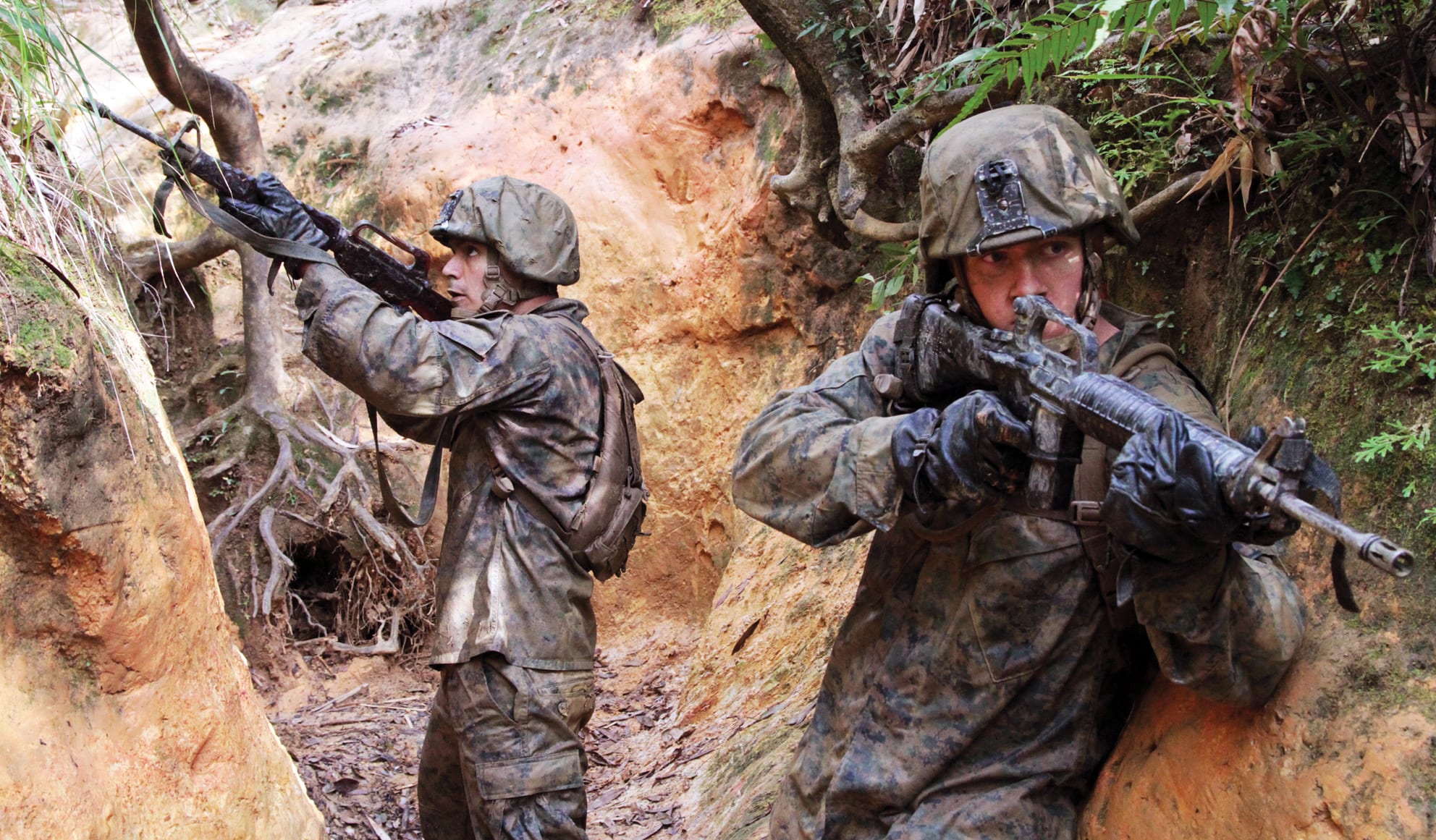 Lance Cpl. Jordan D. Taylor, right, and Cpl. Miguel A. Ruelas provide security during an endurance course Jan. 12 at the Jungle Warfare Training Center on Camp Gonsalves. Both Marines are riflemen with Company K, 3rd Battalion, 1st Marine Regiment, currently assigned to 4th Marine Regiment, 3rd Marine Division, III Marine Expeditionary Force, under the unit deployment program.<br /> (U.S. Marine Corps photo by Lance Cpl. Stephen Himes/RELEASED)