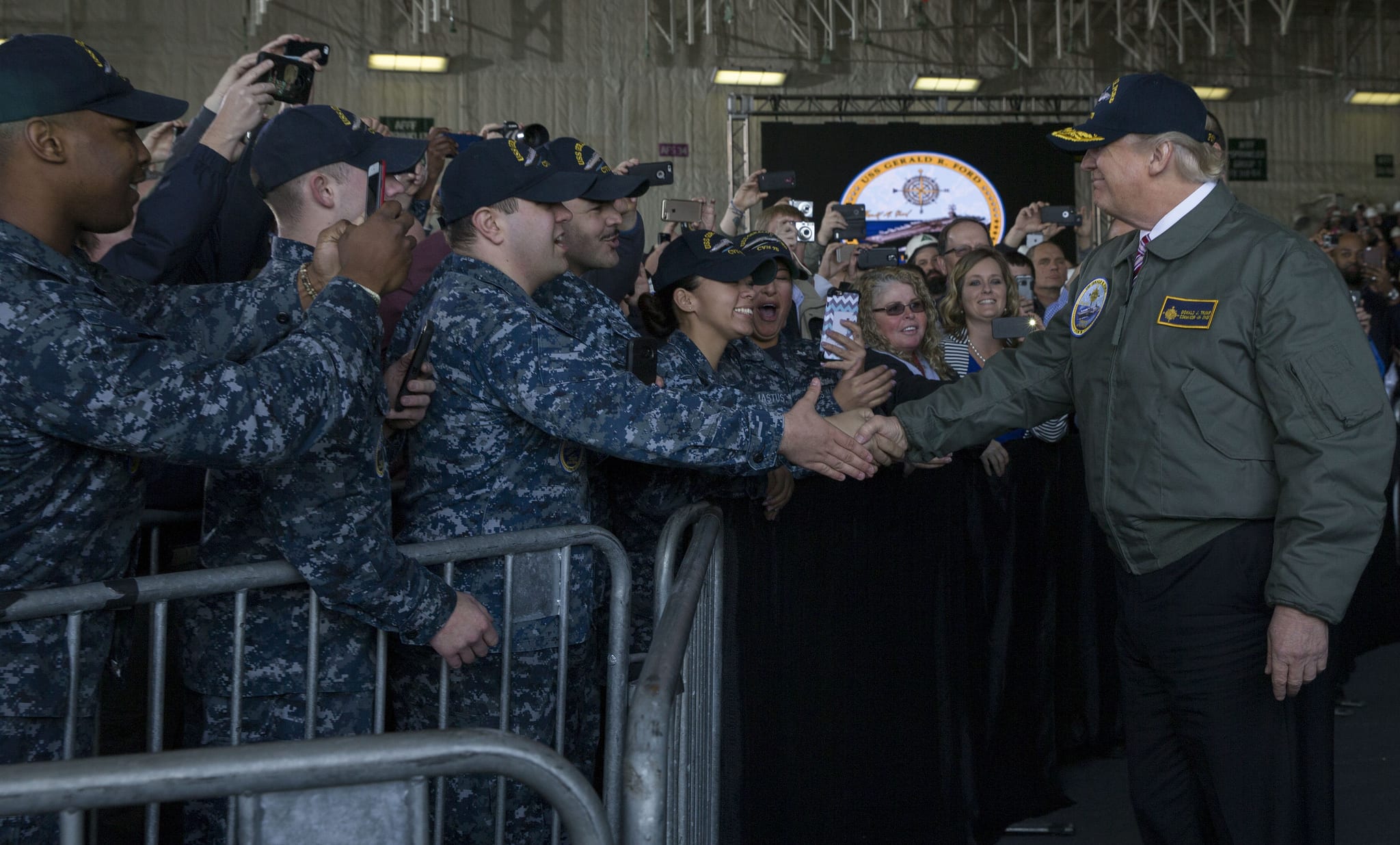 NEWPORT NEWS, Va. (March 2, 2017) President Donald J. Trump greets Sailors after entering the hangar bay aboard Pre-Commissioning Unit Gerald R. Ford (CVN 78). Trump visited March 2 to meet with Sailors and shipbuilders of the Navy’s first-in-class aircraft carrier during an all-hands call inside the ship’s hangar bay. (U.S. Navy photo by Mass Communication Specialist 3rd Class Cathrine Mae O. Campbell/Released)170302-N-ZE240-0292