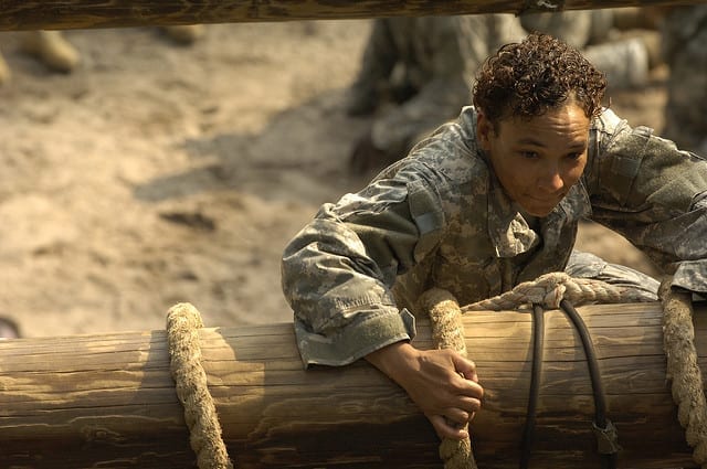 A U.S. Army Pvt. pulls her way to the top of the slide to victory obstacle during the confidence course phase of basic combat training at Fort Jackson, S.C., Aug. 8, 2006. Basic combat training consist of nine weeks of intense training designed to hone skills, teach new skills, optimize physical and mental performance. U.S. Air Force photo by Senior Airman Desiree N. Palacios.