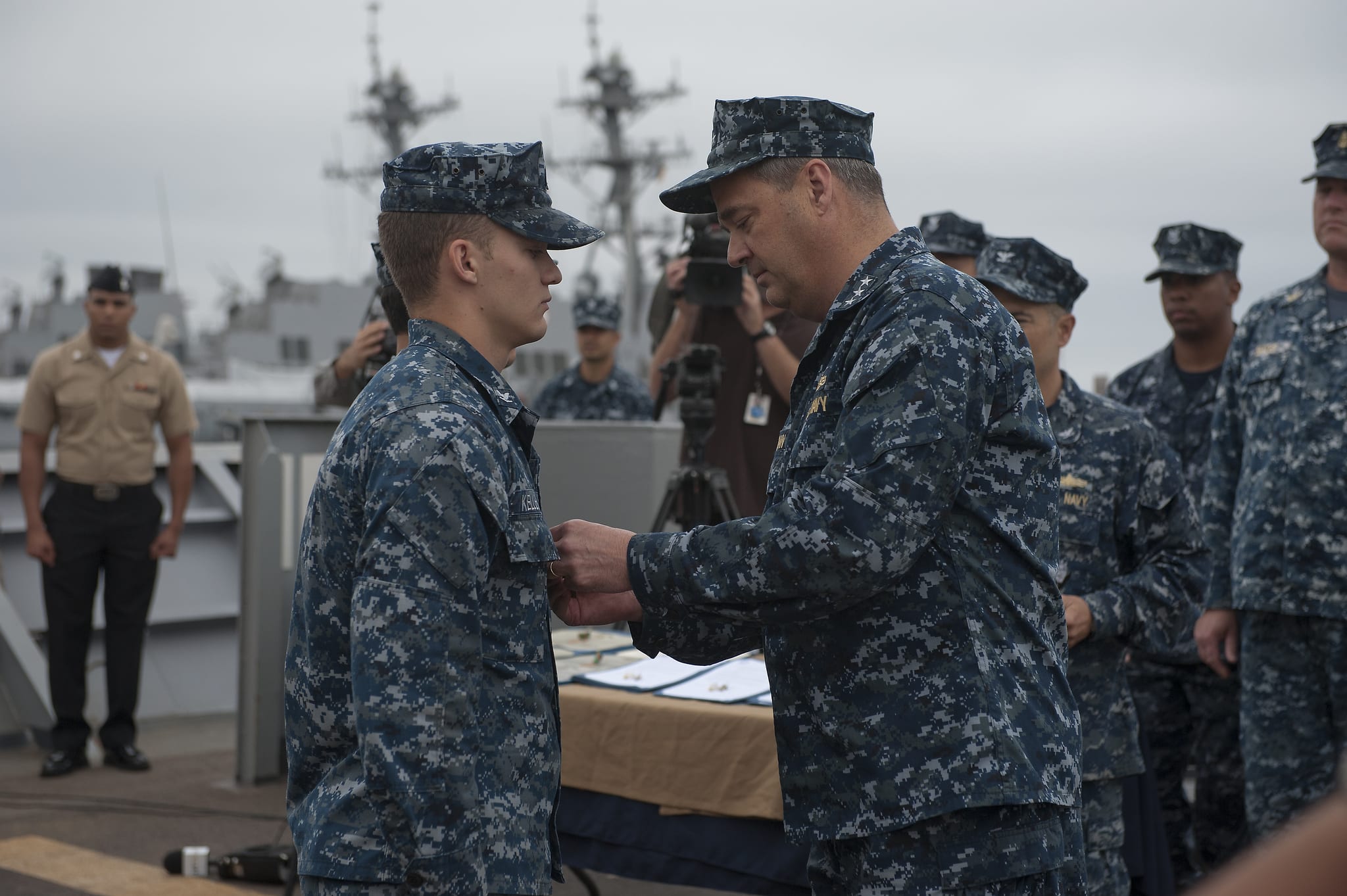 SAN DIEGO (June 12, 2013) Vice Adm. Thomas H. Copeman III, commander of Naval Surface Force, U.S. Pacific Fleet, presents the Navy and Marine Corps Commendation Medal to Religious Programs Specialist 3rd Class Sean Kelley. Kelley received the award for providing assistance and life-saving efforts to those caught in the wake of the tornadoes that devastated Moore, Okla. (U.S. Navy photo by Mass Communication Specialist 3rd Class Christopher Pratt/Released) 130612-N-GH245-016