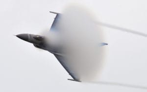 An F-16 Fighting Falcon pilot with the Viper East Demonstration Team from Shaw Air Force Base, S.C., creates a "cone" of condensation Aug. 21, 2010, as he nears Mach 1 during a flyby at an open house at Volk Field Air National Guard Base, Wis. (U.S. Air Force photo/Joe Oliva)