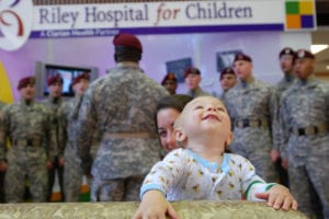 090821-A-5406P-010 Eleven-month-old Dylan grooves to the music while listening to a performance by Paratroopers from the 82nd Airborne Division Chorus at the Riley Hospital for Children in Indianapolis, Ind. Aug. 21. The chorus performed songs and visited sick children at two area children's hospitals while in town for the 82nd Airborne Division Association Convention held in Indianapolis Aug. 19-22. (U.S. Army photo by Staff Sgt. Mike Pryor, 2nd BCT, 82nd Abn. Div. Public Affairs)