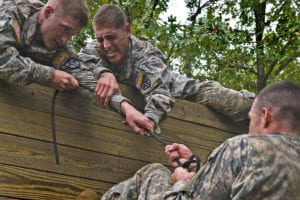 U.S. Soldiers competing in the Army Warfighter Challenge, attempt to pull their comrade over, a fifteen foot wall, at the obstacle course on day two, of the challenge, at Fort Leonard Wood, M.O., Sept. 14, 2010. The 14th Annual Warfighter Challenge brings Military Police units throughout the Army together to determine who is the best in the Military Police field. (U.S. Army photo by Benjamin Faske/Released)