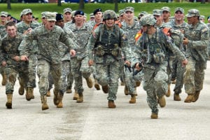 Sgt Gomez and SPC Torres of Fort Richardson Alaska are cheered on as they run down the final straight to the finish line during thirteen mile road march. The 14th Annual Warfighter Challenge at Ft. Leonard Wood Missouri brings military police units throughout the Army together to determine who is the best in the MP field. (DoD photo by Benjamin Faske)