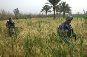 U.S. Army Soldiers from Alpha Battery, 2nd Battalion, 15th Artillery Regiment, 2nd Brigade Combat Team, 10th Mountain Division patrol through farm land during a combined mission with Iraqi Army near Yusufiyah, Iraq, April 21, 2007. (U.S. Army photo by Staff Sgt. Martin K. Newton) (Released)