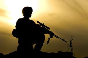 Pfc. Kevin March, armored crewman, assigned to 2nd Squad, 3rd Platoon, Company C., 1st Battalion, 66th Armored Regiment, 1st Brigade Combat Team, 4th Infantry Division, stands atop a cliff overlooking the Arghandab River Valley Jan. 31. March, a native of Dodgeville, Wis., was conducting a foot patrol with his squad to search orchards throughout the district and build rapport with the local population. During their patrols, 2nd squad must maneuver their way through the Arghandabs many obstacles, including: farmer-built mud walls, irrigation canals, densely populated orchards, foot-wide pathways through long stretches of boggy flats and even a 30-foot-tall wall they must climb during their patrol.