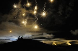 Participants in the Department of the Army Best Warrior Competition fire at targets as the night sky is illumintated with simulated munitions, adding a breath of realism to the night fire event. The competition was held at Sept. 27-Oct. 2 at Fort Lee, Va. (photo by T. Anthony Bell)