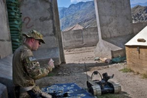 Explosive ordnance disposal technician, U.S. Army Spc. Andrew B. Clement, a native of Jackson, Tenn., assigned to 129th EOD, attached to 3rd Brigade Combat Team, 25th Infantry Division, Task Force Bronco, gets a refresher course on a Pacbot 310 EOD robot at Combat Outpost Honaker-Miracle in eastern Afghanistan's Kunar province, Aug. 1. Clement said the robot is compact enough to be carried in a backpack for dismounted patrols.