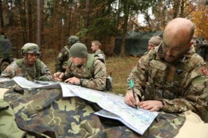 A U.S. Soldier, left, of 2nd Battalion, 12th Cavalry Regiment, 1st Brigade Combat Team, 1st Cavalry Division, an Armenian soldier, center, and a Danish soldier update map information during exercise Combined Resolve III at the Joint Multinational Readiness Center in Hohenfels, Germany, Nov. 7, 2014. Combined Resolve III is a multinational exercise, which includes more than 4,000 participants from NATO and partner nations, and is designed to provide a complex training scenario that focuses on multinational unified land operations and reinforces the U.S. commitment to NATO and Europe. (U.S. Army photo by Spc. John Cress Jr./Released)