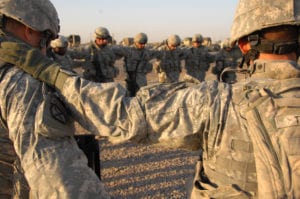 U.S. Army Soldiers from Alpha Battery, 2nd Battalion, 32nd Field Artillery Regiment say a prayer Oct. 29, 2007, at Forward Operating Base Liberty, Iraq, before a mission. (U.S. Army photo by Spc. Charles W. Gill) (Released)