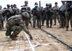 Sgt. Kyron Brown, a transportation management coordinator with Headquarters and Headquarters Company, Special Troops Battalion, 3rd Infantry Division Sustainment Brigade, goes over the company’s base defense plan during a Base Defense Live Fire Exercise on Jan. 29, 2019 at Ft. Stewart, Ga. Brown was a squad leader during the exercise and was responsible for Soldiers’ movements during the live fire. (U.S. Army photo by Sgt. Elizabeth White/Released)