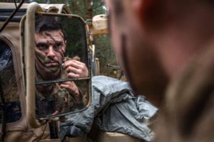 U.S. Army Sgt. Forrest Layton, an American sniper assigned to Battle Group Poland, applies face paint during NATO joint training exercise, Anakonda-18 (AN-18), at Bemowo Piskie Training Area, Poland, Nov. 14. AN-18 is a 10-day log training exercise designed to strengthen the interoperability between participating nations by developing strategies in defensive operations and execution to better prepare against any form of threat against NATO allies. (Photo by U.S. Army Sgt. Sarah Kirby)