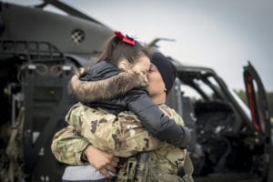 U.S. Army Chief Warrant Officer 3 Austin Randolph hugs his daughter Elliana before taking off for a deployment in support of Operation Freedom's Sentinel in Afghanistan on Joint Base McGuire-Dix-Lakehurst, N.J., Jan. 3, 2019. Randolph is a UH-60L Black Hawk helicopter pilot with the New Jersey National Guard's Det. 2, Charlie Company, 1-171st General Support Aviation Battalion (MEDEVAC). (U.S. Air National Guard photo by Master Sgt. Matt Hecht)