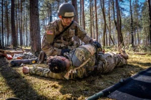 Spc. William Horne, combat medic, assigned to 1st Infantry Division treats and evacuates simulated casualties during U.S. Army Europe Expert Field Medical Badge Combat Testing Lane 3 at Grafenwoehr Training Area, Germany, March 29, 2019. To qualify for the EFMB, Soldiers must endure a multitude of events such as land navigation, physical fitness test, medical evacuations, weapons function checks, ruck march, chemical biological radioactive nuclear evaluations, written test, and medical treatments. (U.S. Army photo by Maj. Robert Fellingham, 30th Medical Brigade)