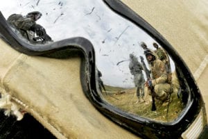 An Iraqi soldier's goggles catch the reflection of U.S. Army Staff Sgt. Kevin Murphy, left, as he instructs Iraqi soldiers of 2nd Battalion, 11th Brigade, 3rd Iraqi Army Division, on individual movement techniques at the Ghuzlani Warrior Training Center, Feb 2. Murphy and fellow Soldiers of 1st Squadron, 9th Cavalry Regiment, 4th Advise and Assist Brigade, 1st Cavalry Division, run Iraqi battalions through 25-day training cycles at the GWTC in order to teach them collective unit-level warfighting drills in order to bolster IA independence on national defense operations. (U.S. Army photo by Sgt. Shawn Miller)