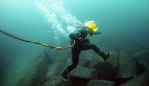 110629-N-XD935-139<br /> VALPARAISO, Chile (June 29, 2011) Navy Diver 3rd Class Bryan Myers, assigned to Mobile Diving and Salvage Unit (MDSU) 2, leaps from rock to rock along the ocean floor during diving operations. MDSU-2 is participating in Navy Diver-Southern Partnership Station, a multinational partnership engagement intended to increase interoperability and partner nation capacity through diving operations. (U.S. Navy photo by Mass Communication Specialist 1st Class Jayme Pastoric/Released)