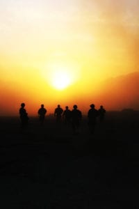 KANDAHAR, Afghanistan  Soldiers with 2nd Brigade Combat Team, 4th Infantry Division, walk into the sunset to catch their flight out of Forward Operating Base Pacemaker, Dec. 25. The Soldiers were on a mission to deliver holiday gifts of cookies, candy and personal hygiene products to the outlying FOB. When the Chinook helicopter flew in to pick the Soldiers up, it made dust go into the air, which caused the foggy look of the photograph. (U.S. Army photo by Sgt. Ruth Pagan, 2nd BCT, 4th Inf. Div., PAO)