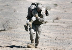 Navy Corpsman James Hyten, a native of Indianapolis, Ind. and medical technician for Combat Logistics Battalion 6, 2nd Marine Logistics Group, based out of Camp Lejeune, N.C., carries a Marine during the Integrated Training Exercise at Twentynine Palms, Calif., May 27, 2013. The battalion sent four convoys over two days to train Marines on resupply operations and to provide realistic "local-national" training for the Marines before CLB-6's upcoming deployment in support of Operation Enduring Freedom.