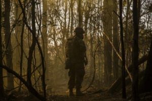 A U.S. Navy Corpsman assigned to Field Medical Training Battalion East (FMTB-E), checks on members of his squad during a final exercise (FINEX) at Camp Johnson, N.C., March 1, 2016. FINEX is a culminating event at FMTB-E which transitions Sailors into the Fleet Marine Force. (U.S. Marine Corps photo by Sgt. James R. Skelton/Released)