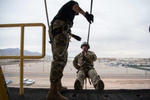 Army Cpl. Alexandra Perez, Iron Training Detachment air assault instructor, instructs Air Force Staff Sgt. James Tienor, 377th Security Forces Group Air Assault trainee, on proper rappelling techniques at Fort Bliss, Texas, March 8, 2019. Nine members of the 377th SFG at Kirtland Air Force Base, N.M., graduated from the Fort Bliss Air Assault Training School March 11, 2019. (U.S. Air Force photo by Staff Sgt. J.D. Strong II)