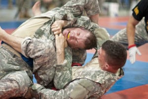 Army Reserve corporals Jabriel Santos, right, and Francis Kvarta, fight for a dominating position during the Modern Army Combatives tournament at the 2013 U.S. Army Reserve Best Warrior Competition at Fort McCoy, Wis., June 27. Santos is a cargo specialist representing the 1st Mission Support Command and is a native of Caguas, Puerto Rico. Kvarta is a supply sergeant representing the 99th Regional Support Command and a native of Johnstown, Pa.