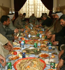 Warhorse Soldiers and Diwaniya sheiks break bread together and discuss local issues in an assessment of a district of the province on Dec. 14.