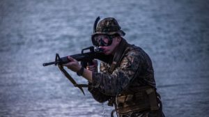 A U.S. Marine with Bravo Company, 1st Battalion, 3rd Marine Regiment, scans his surroundings during an amphibious assault exercise on Marine Corps Base Hawaii, April 28, 2020. Bravo Company conducted the boating event to increase proficiency in areas that are uncommon to infantry training within the Marine Corps while mitigating risks brought on by COVID-19. (U.S. Marine Corps video by Lance Cpl. Jacob Wilson)