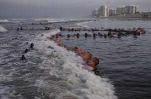 CORONADO, Calif. (May 4, 2020) SEAL candidates participate in surf immersion during Basic Underwater Demolition/SEAL (BUD/S) training at Naval Special Warfare (NSW) Center in Coronado, Calif., May 4, 2020. NSW Center restarted paused portions of its SEAL and Special Warfare Combatant-craft Crewman (SWCC) selection-and-assessment training following careful planning that included implementing COVID-19 mitigation efforts based on CDC recommendations and Department of Defense medical guidance. The health, safety and well-being of students remains NSW Center’s top priority. Any student showing signs of illness will be removed from training and evaluated by medical professionals before returning to training. NSW Center provides initial and advanced training to the Sailors who make up the Navy’s SEAL and Special Boat Teams. (U.S. Navy photo by Mass Communication Specialist 1st Class Anthony Walker/Released) 200504-N-QC706-1624