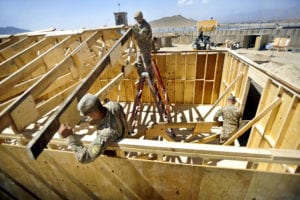 U.S. Army soldiers with the 149th Vertical Construction Company, Kentucky National Guard, hammer a truss in to place during the construction of a building that will be used as living quarters for Soldiers on Forward Operating Base Lightning, Sept. 22, 2013. (U.S. Army photo by Staff Sgt. Todd A. Christopherson, 4th Brigade Combat Team Public Affairs)