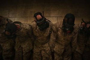 Recruits of Charlie Company, 1st Recruit Training Battalion, shake their heads during chemical warfare defense training June 3, 2014, on Marine Corps Recruit Depot Parris Island, S.C. The recruits shook their heads and performed other exercises to prove their gas masks worked despite vigorous activity. (U.S. Marine Coprs photo by Cpl. Octavia Davis/Released)