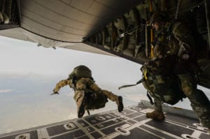 U.S. Army Green Berets from the 7th Special Forces Group jump out of a C-130H3 Hercules for Emerald Warrior at Hurlburt Field, Fla., April 22, 2015. Emerald Warrior is the Department of Defense's only irregular warfare exercise, allowing joint and combined partners to train together and prepare for real-world contingency operations. (U.S. Air Force photo by Tech. Sgt. Joshua J. Garcia /Released)