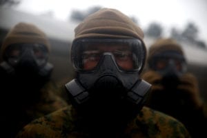 A U.S. Marine with Black Sea Rotational Force 17.1 dons his M50 gas mask prior to a company run aboard Adazi Military Base, Latvia, April 15, 2017. The Marines are in Latvia for Exercise Summer Shield, a multinational training evolution designed to train with NATO Allies in Europe. (U.S. Marine Corps photo by Cpl. Sean J. Berry)