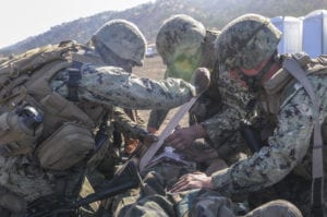 FORT HUNTER LIGGETT, Calif. (Nov. 8, 2019) Seabees assigned to Naval Mobile Construction Battalion (NMCB) 3 provide field medical care to a simulated casualty during a mass casualty drill as part of NMCB-3’s field training exercise (FTX) at Fort Hunter Liggett, Calif. The battalion is conducting Operation Bearing Duel FTX that prepares and tests the battalion’s ability to enter a hostile location, build assigned construction projects and defend against enemy attacks using realistic scenarios while being evaluated by Naval Construction Group 1. (U.S. Navy photo by Mass Communication Specialist 2nd Class Michael Lopez/Released) 191108-N-TP832-1061