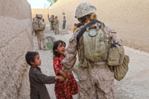 Lance Cpl. Chandra Francisco, with Female Engagement Team 15 in Sangin District, Helmand province, holds hands and talks with Afghan children during a patrol, July 17. Chandra, of Monroe, Wash., was put on FET by her parent unit, II Marine Expeditionary Force Headquarters Group, last fall, and says, "At first I really had no idea what I was getting into. Once I started training I loved it. This is by far one of the greatest experiences I’ve ever gotten to have."