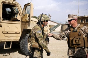 Marine Corps Gen. John R. Allen, commander of NATO and International Security Assistance Force troops in Afghanistan, gives a soldier assigned to Forward Operating Base Ghazni a thump on his body armor as he thanked him for his service and sacrifice. During Allen's battlefield circulation to Regional Command-East Aug. 15, he received several operational briefings, met with the Ghazni provincial governor and thanked U.S., Polish and Afghans for their commitment to the future of Afghanistan. ISAF is a key component of the international community's engagement in Afghanistan, assisting Afghan authorities in providing security and stability while creating the conditions for reconstruction development.