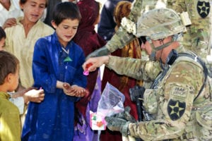 U.S. Army Command Sgt. Maj. Joseph Dallas, right, the command sergeant major of the 5th Battalion, 20th Infantry Regiment, 2nd Infantry Division, gives toys to Afghan children during Operation Southern Fist in Obezhan Kalay village, Spin Boldak district, Afghanistan, Sept. 30, 2012. The Afghan-led operation focused on denying the enemy freedom of movement and connecting area villagers with the Afghan government. (U.S. Army photo by Staff Sgt. Brendan Mackie/Released)