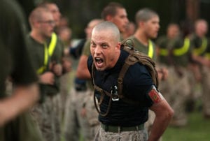 Sgt. William Loughran encourages recruits from Kilo Company, 3rd Recruit Training Battalion, to give 100 percent during physical training at Marine Corps Recruit Depot Parris Island, S.C., Sept. 18, 2013. Loughran joined the Corps in 2004 and became a drill instructor in 2012. “[Being a drill instructor] is the most demanding duty … yet probably the most rewarding thing I have ever done,” Loughran said. About 600 Marine Corps drill instructors train about 20,000 recruits who come to Parris Island annually.(U.S. Marine Corps photo by Cpl. Caitlin Brink/Released)